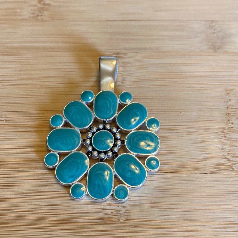 Necklace brooch turquoise on side and red on the other side.